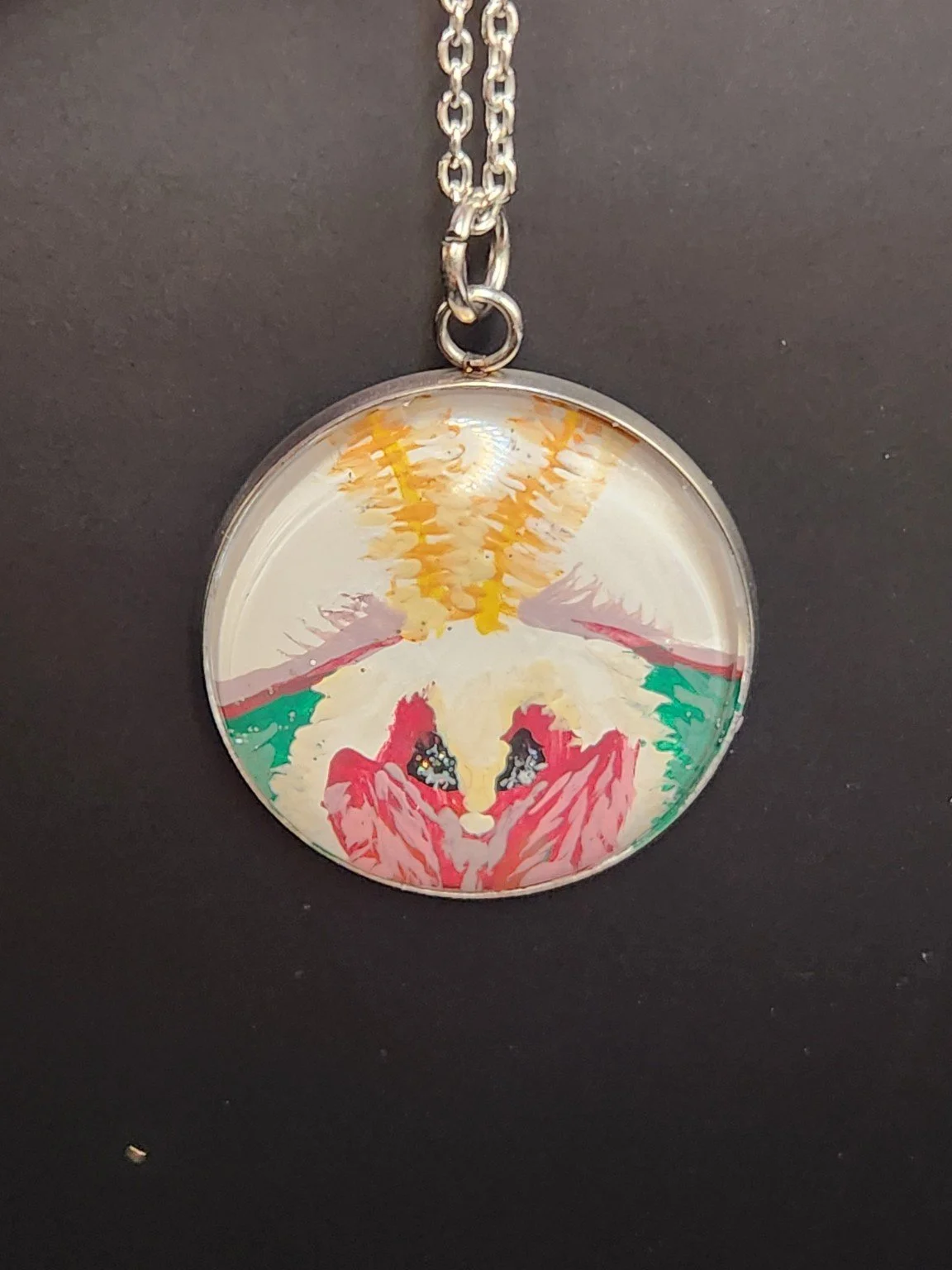 White-background luna moth face art pendant shown on a silver-tone chain against a dark background. Chain not included.