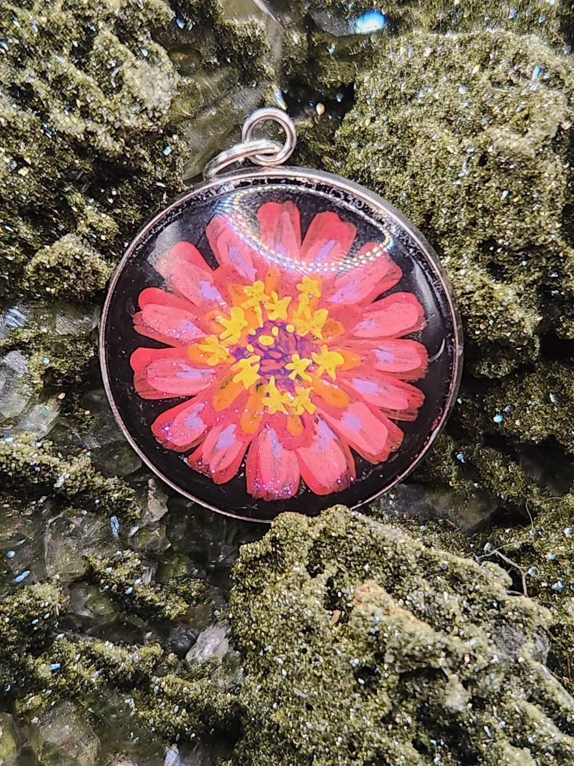 Zinnia flower pendant on a crystal display; display not included.