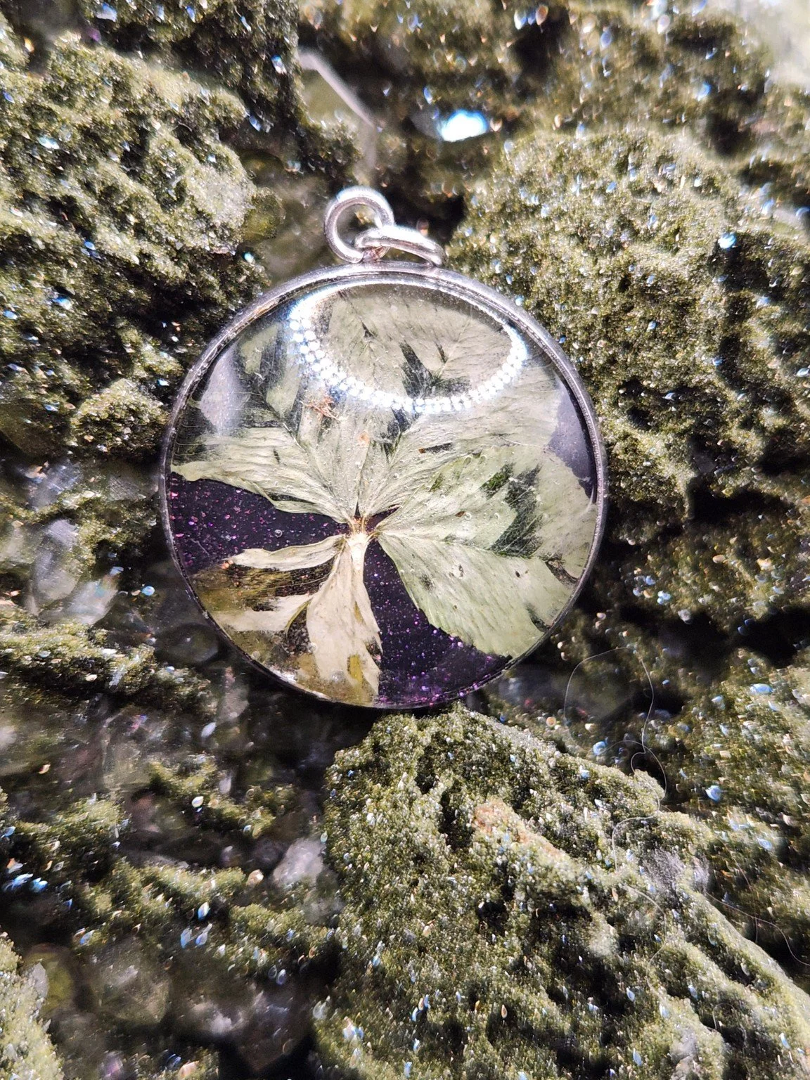 Perfectly Imperfect I003: real clover pendant with purple glitter on a crystal display. Display not included.
