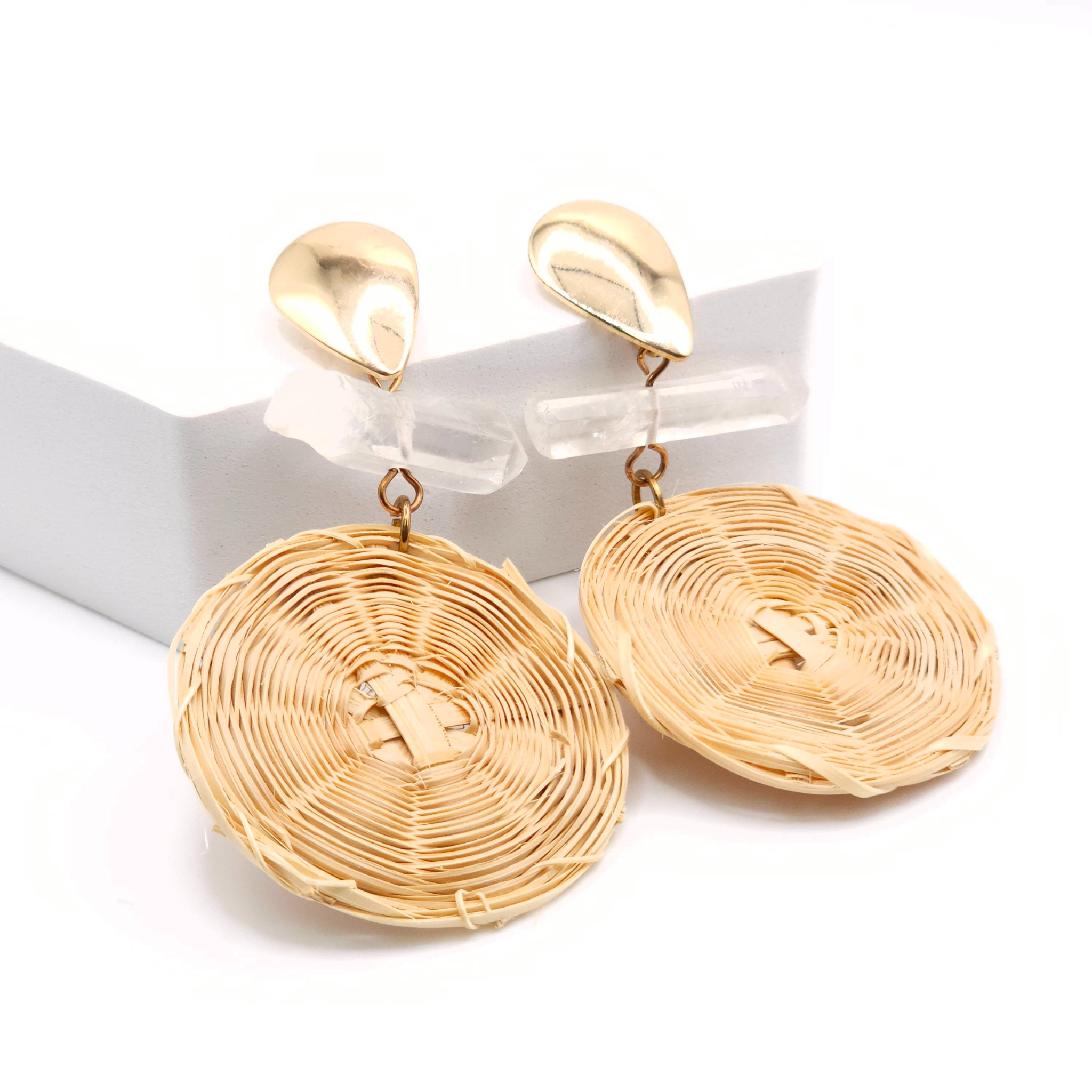Pair of gold teardrop-shaped earrings displayed on white background
