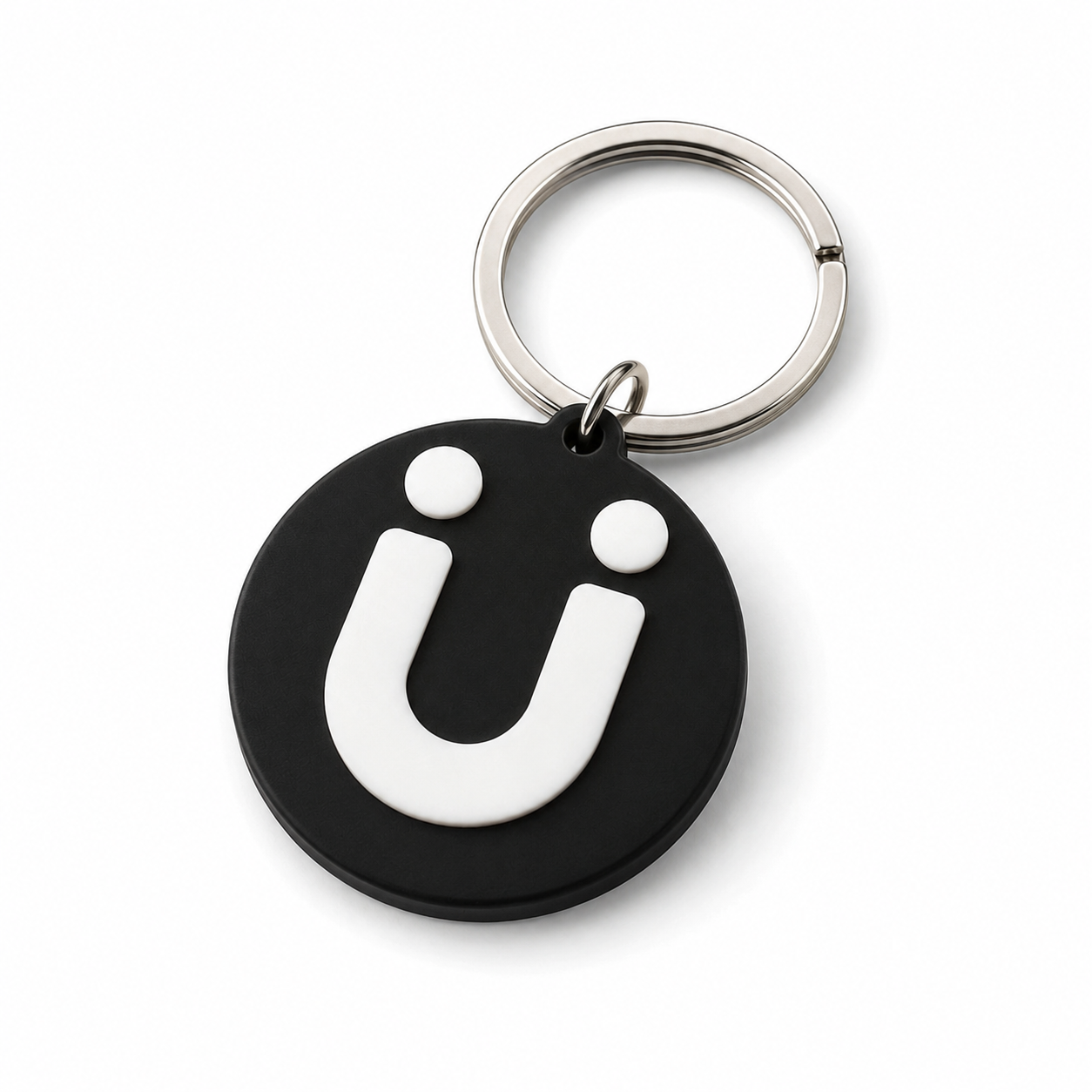 Black round keychain with a white logo and two white dots on top, attached to a silver key ring.