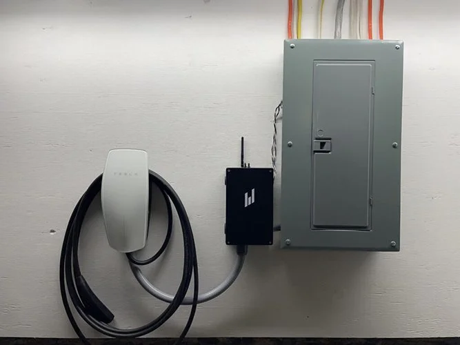 Electrical panel with EV charging station and Wi-Fi router on wall