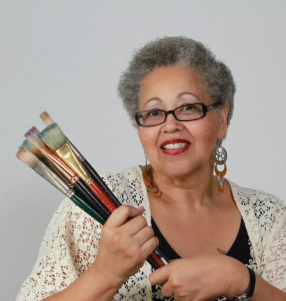 Sam I Am holding paintbrushes