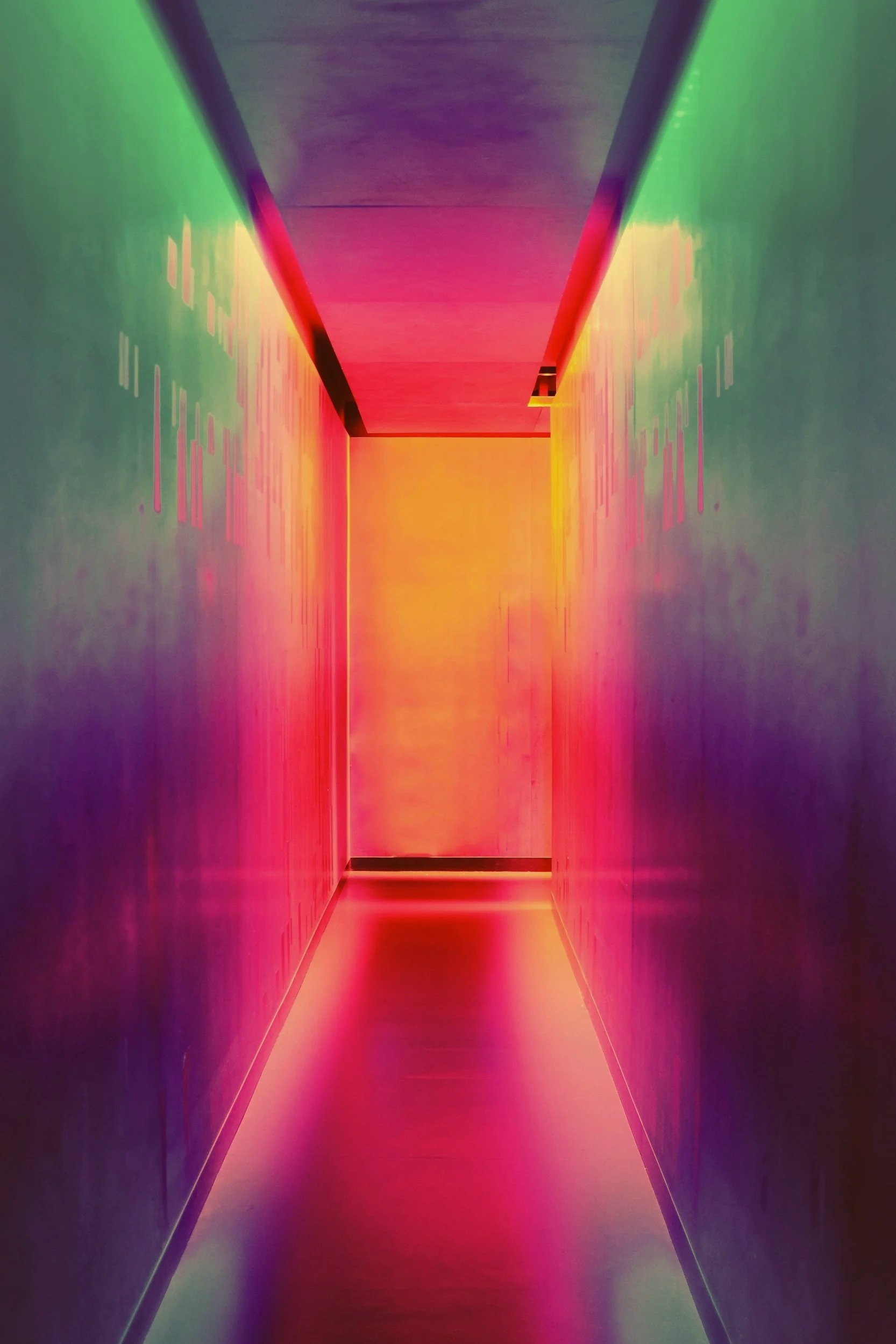 A colorful hallway illuminated with rainbow lights, creating a vibrant and luminous atmosphere.