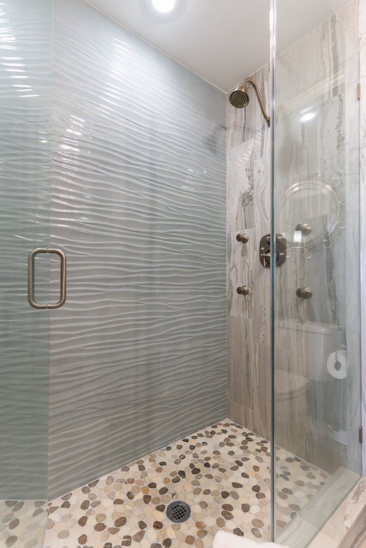 Primary shower with body sprays and teak seat