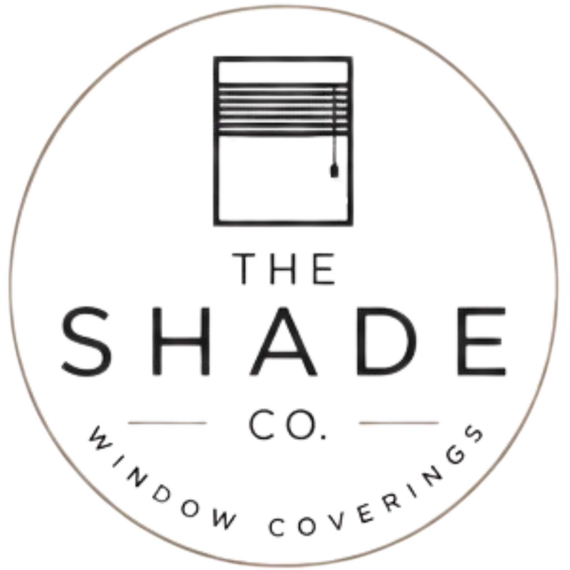 Close-up of a circular logo featuring a window with horizontal blinds and text below reading THE SHADE CO. The logo has a white background and a thin circular border.