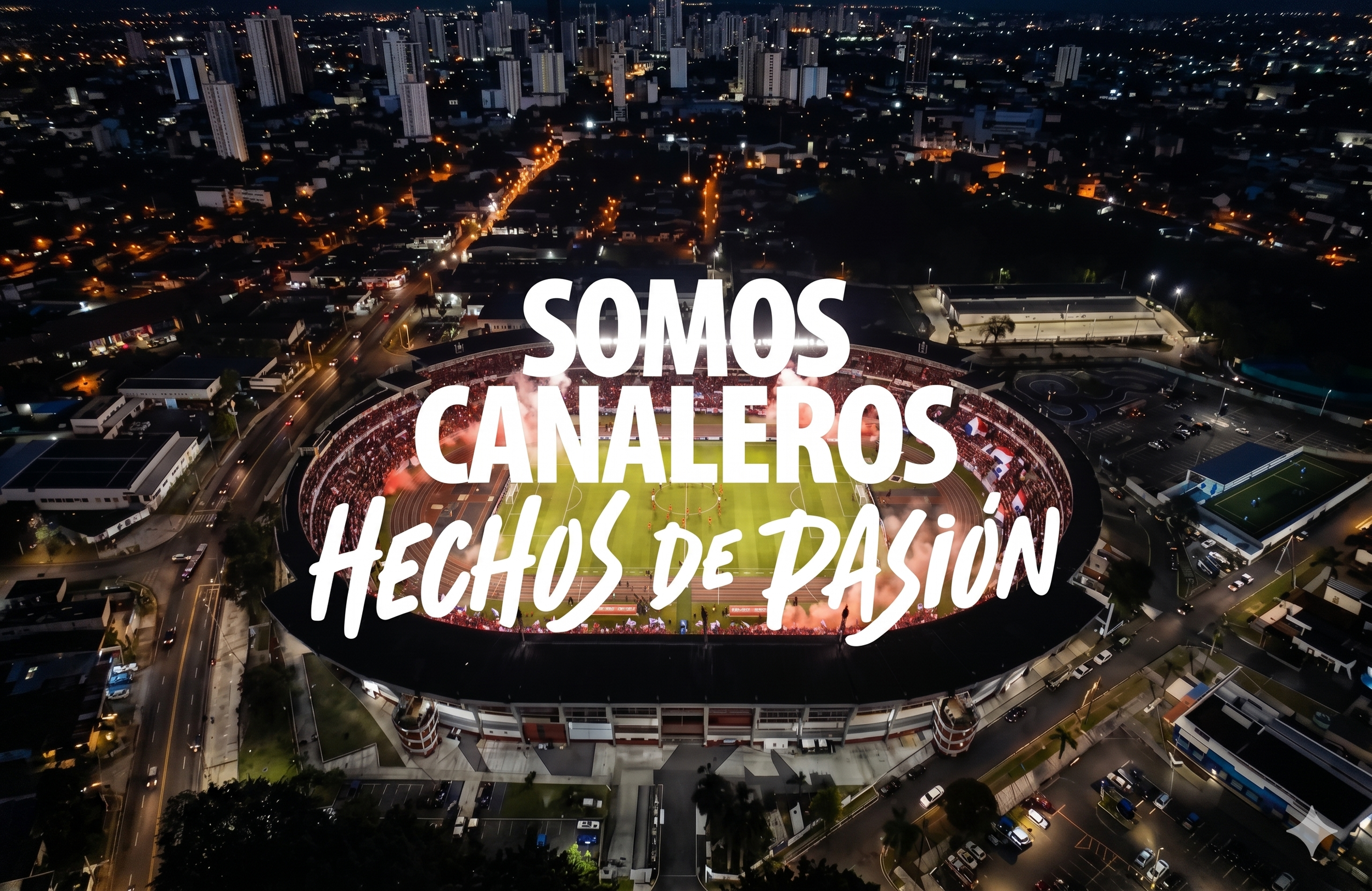 Nighttime aerial view of a city with a large, illuminated stadium in the foreground. Overlayed text in Spanish reads: "SOMOS CANARIOS HECHOS DE PASIÓN."