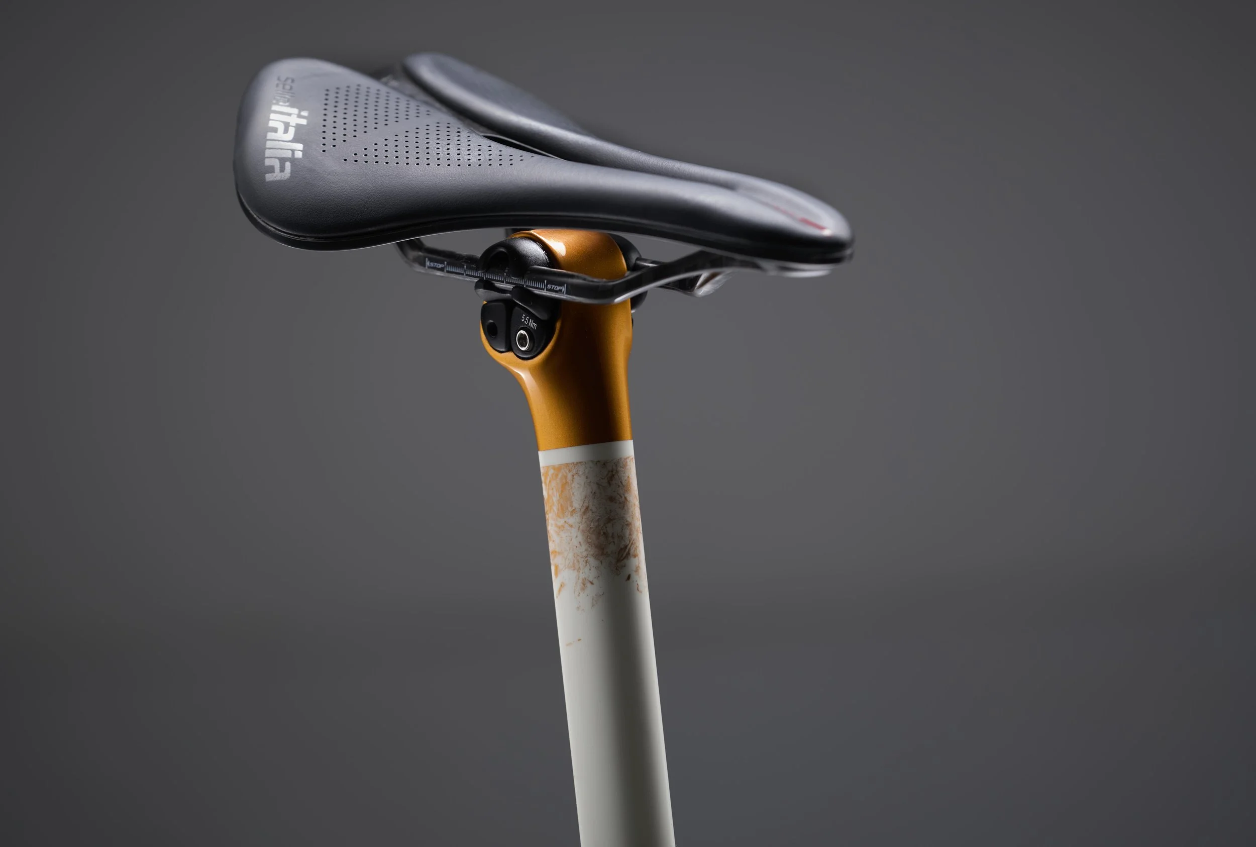Detail of paint on ENVE seat post on grey background