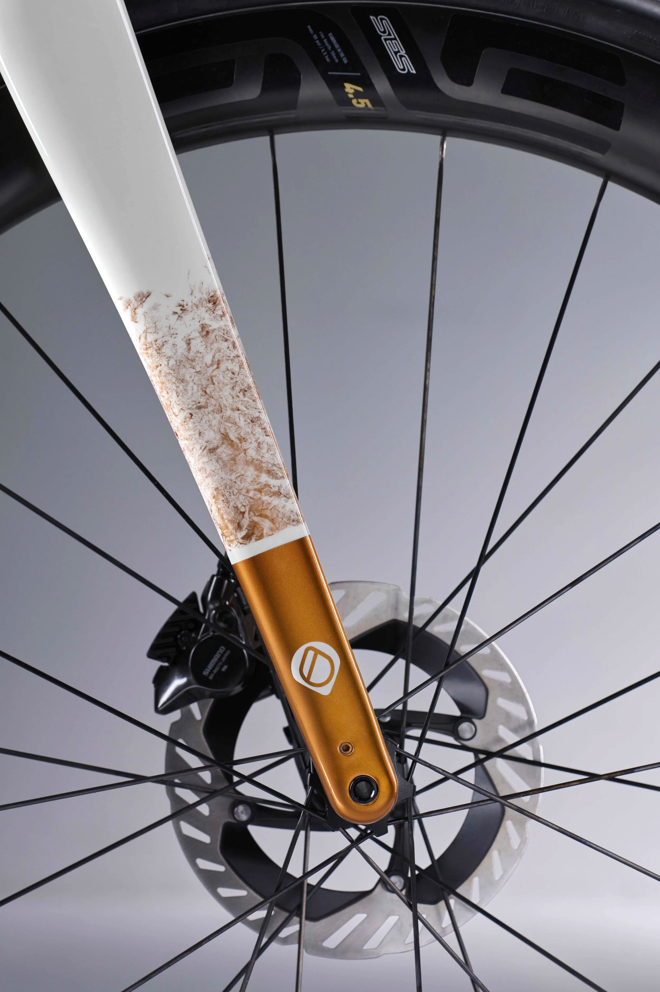 Detail image of ENVE front fork showing copper paint scheme and Shimano dura-ace brake caliber and front brake disc