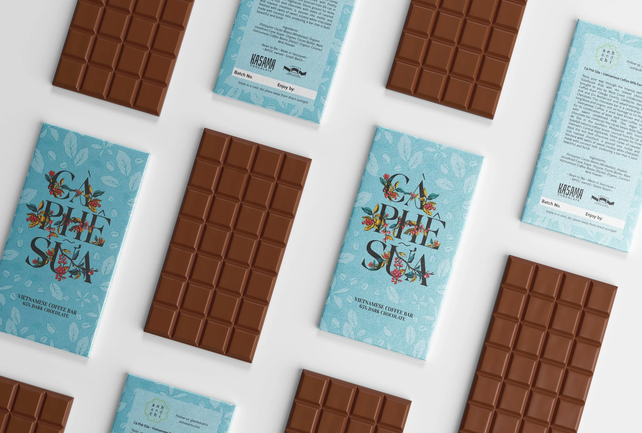 Multiple milk chocolate bars and paper wrappers with blue backgrounds, floral designs, and text related to a Vietnamese coffee-themed chocolate brand, arranged on a white surface.