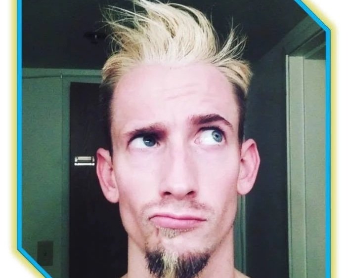 A man with styled blond hair and a goatee looks up and to the side with a confused or pondering expression. Punk Rock , Brice Williams ; Brice A. Williams ; Coach Brice Williams.