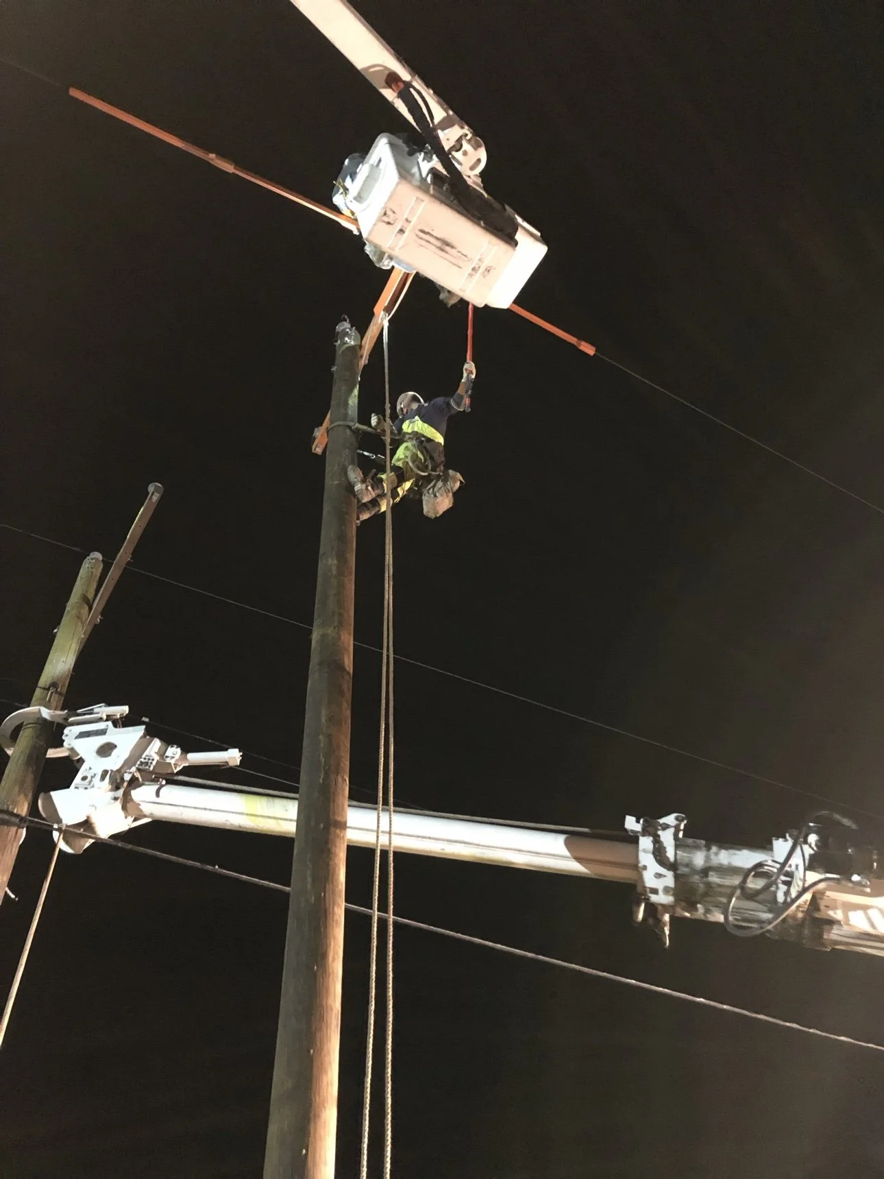 Elevate Utilities lineman performing emergency line work at night