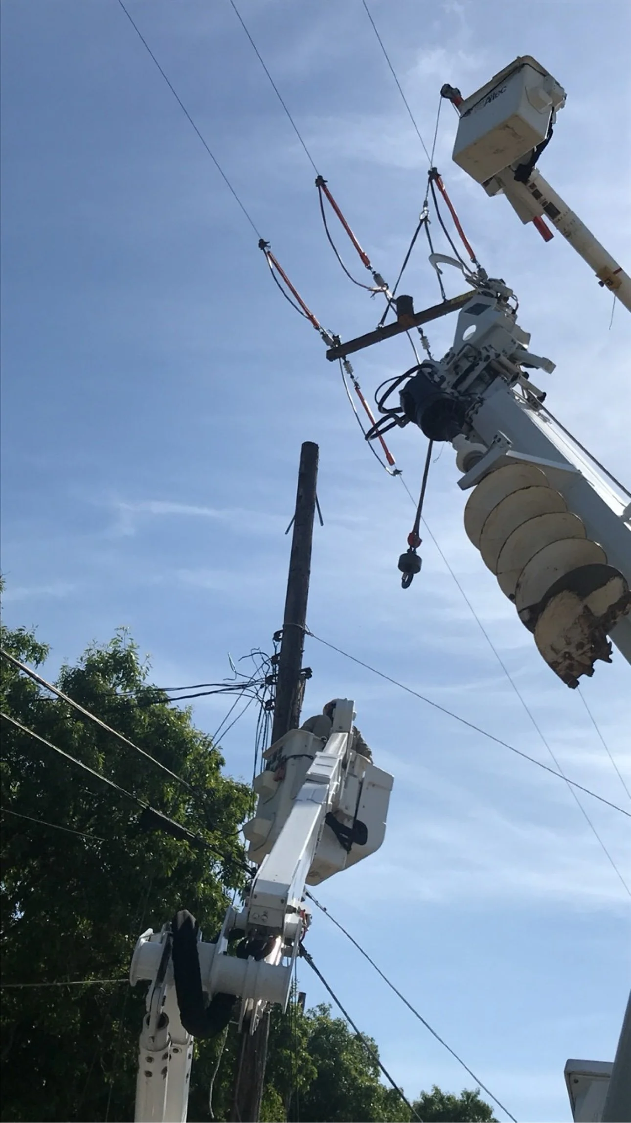 Elevate Utilities digger derrick setting a utility pole