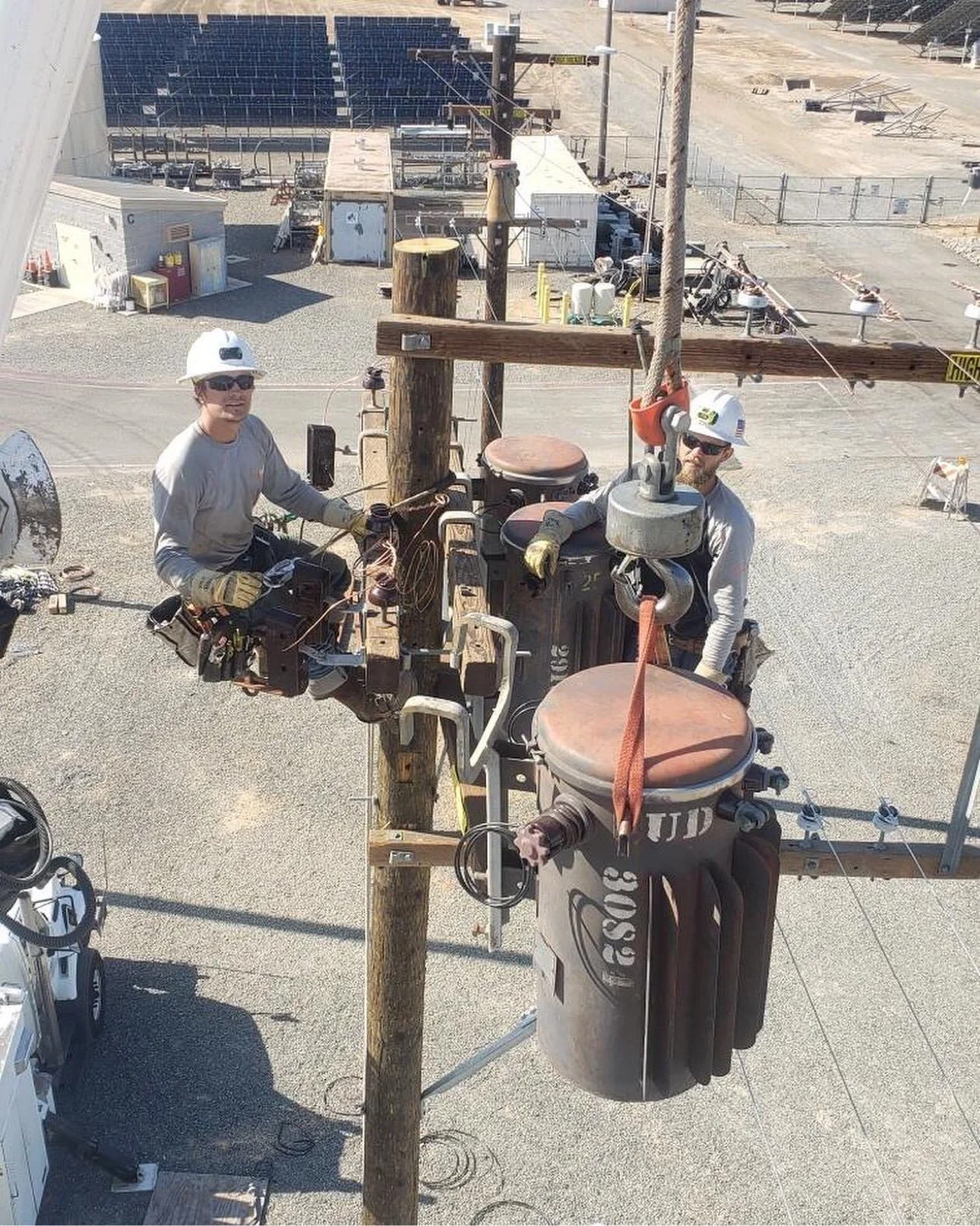 Elevate Utilities linemen hanging a transformer during overhead line work