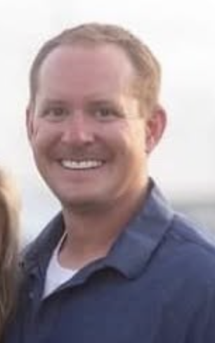 smiling man in a blue polo
