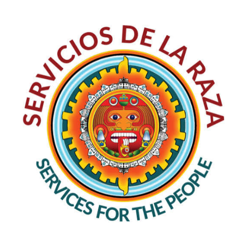 A colorful logo featuring a traditional Aztec mask with bright colors, surrounded by an abstract circular design. The logo includes the text 'Servicios de la Raza' at the top and 'Services for the People' at the bottom, both in bold letters.