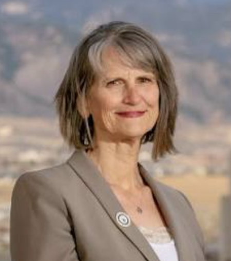 smiling woman in a grey suit