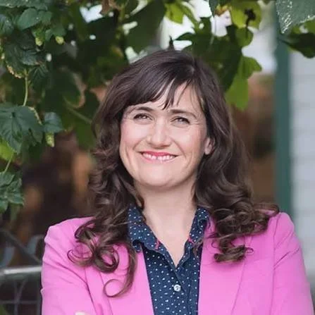 smiling woman in a pink jacket
