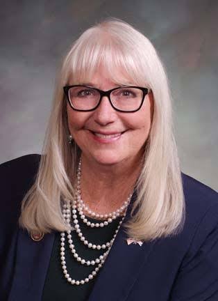 Smiling woman with blonde hair and glasses
