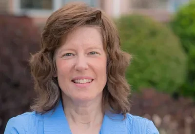 smiling woman in a blue shirt