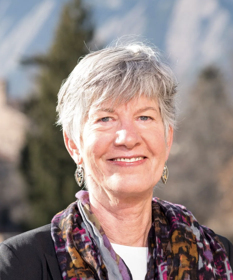 Smiling woman with short silver hair