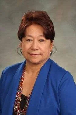 woman with brown hair and a blue jacket