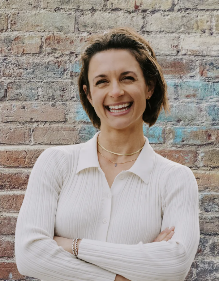 smiling woman with short brown hair and a white button down shirt