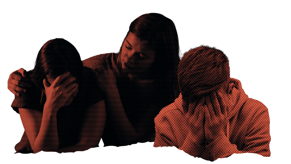 Three people sitting at a table, each covering their face with their hands, appearing distressed or upset.