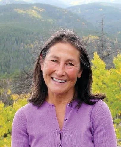 smiling woman with a purple shirt