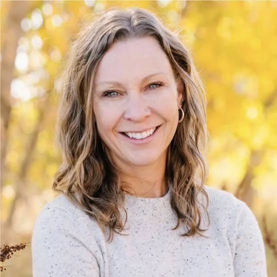 Smiling blonde women by fall trees