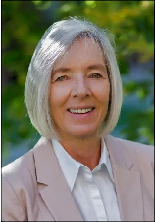 Woman with silver hair and ivory jacke
