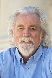 smiling man with a white beard and long white hair