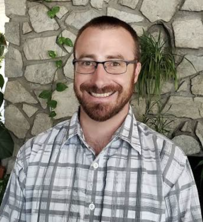 Somling man with glasses and a dark beard
