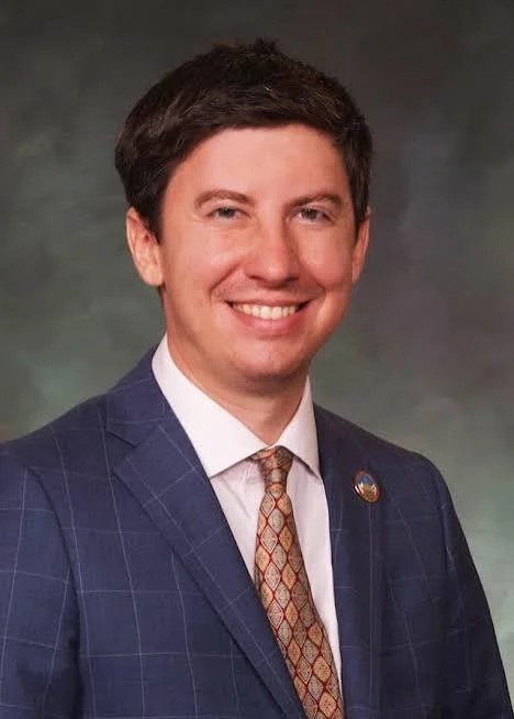 smiling man in a blue suite