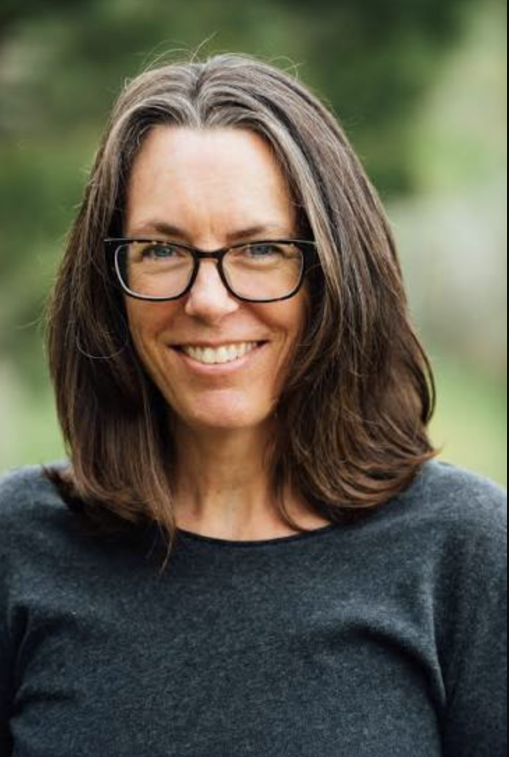 Smiling woman with brown hair and glases