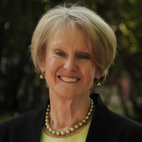 smiling woman with short hair and a black jacket