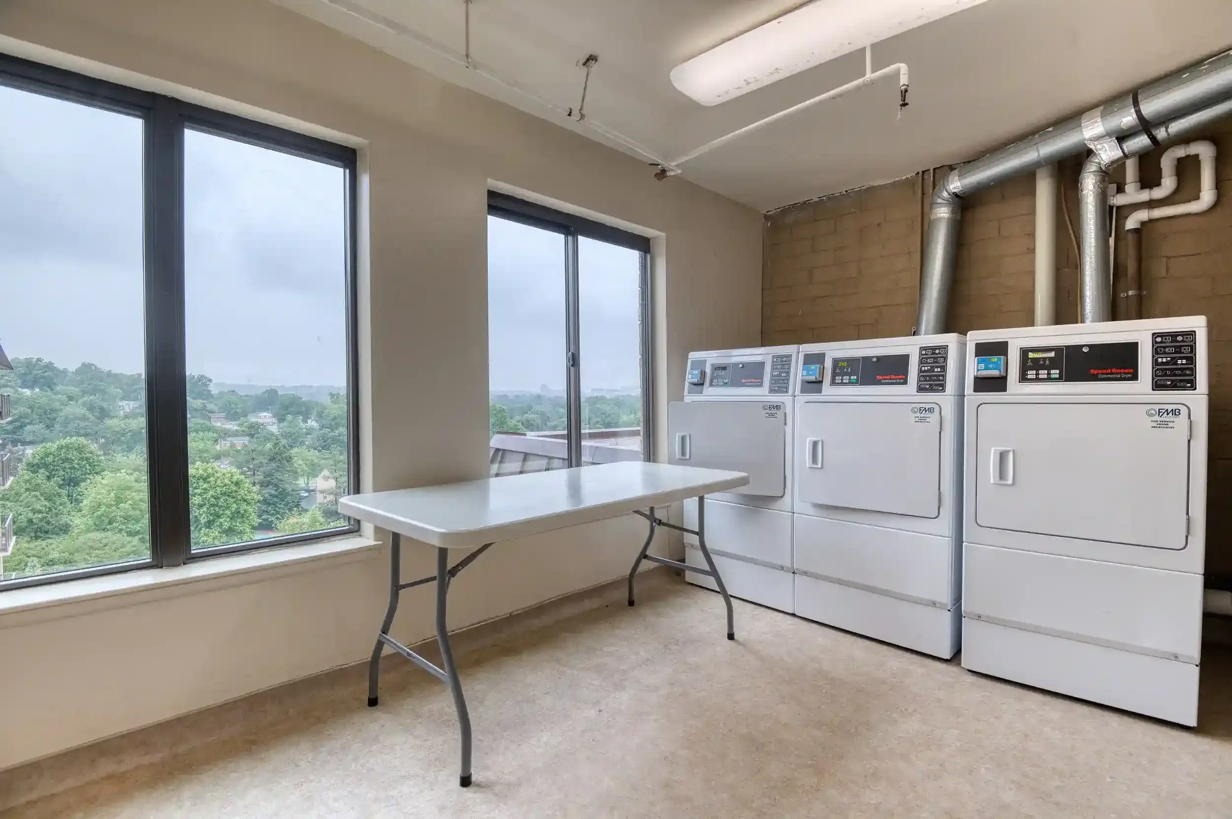 Laundry Room (View 2) – Windows with a view overlooking the treetops that make every laundry day pleasant. 