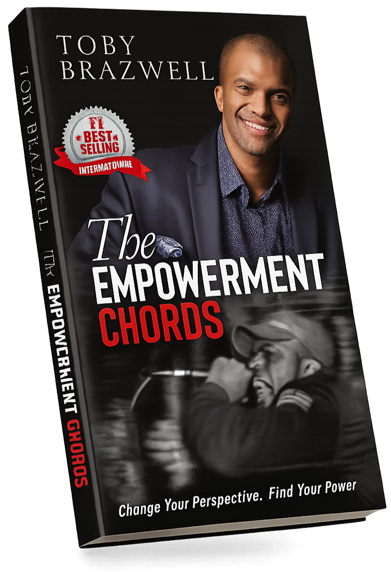 Book titled "The Empowerment Chords" by Toby Brazwell, featuring a smiling man in a blazer on the cover, with a monochrome photo of a person holding a microphone, and text that says "Change Your Perspective. Find Your Power."