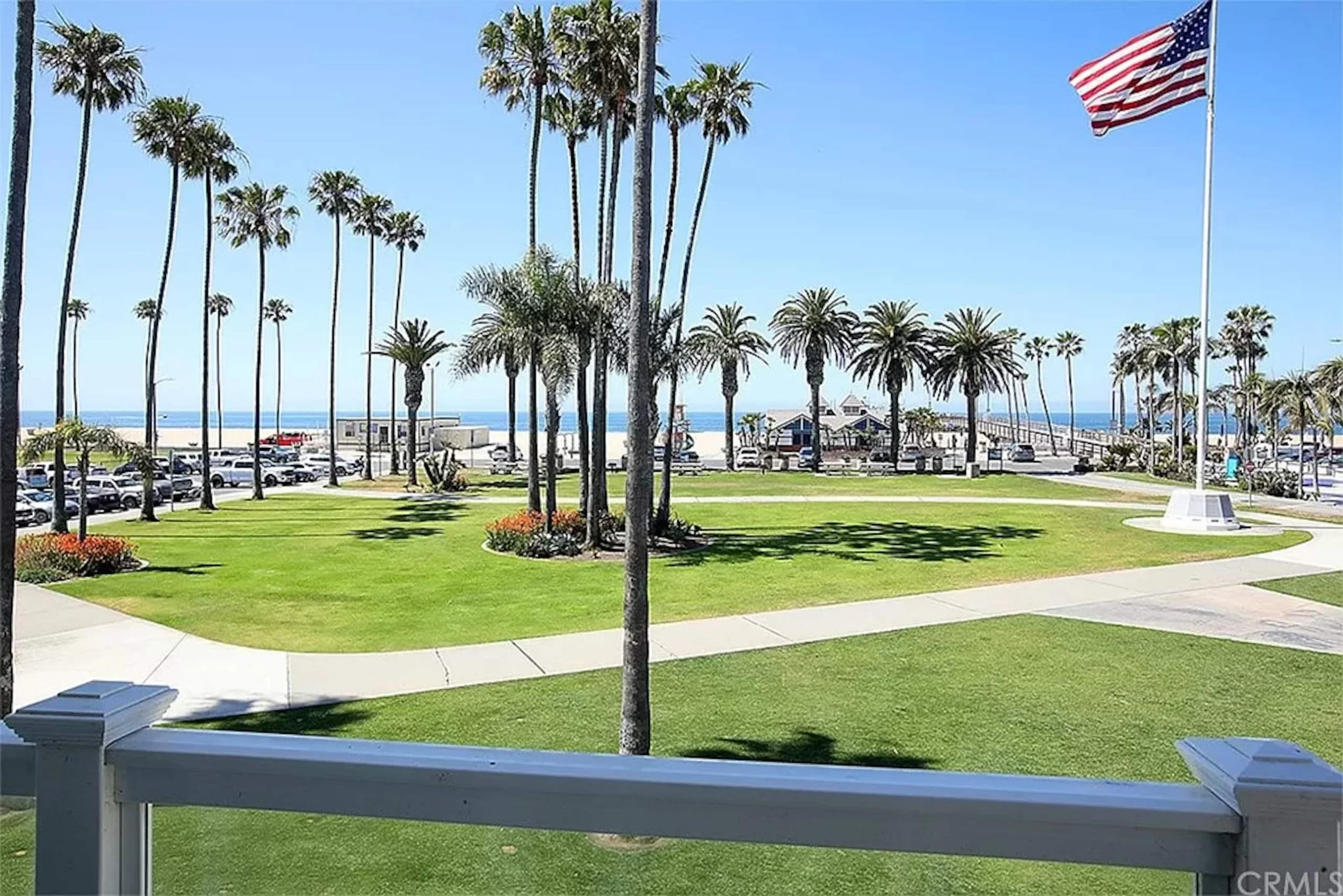 View of palm trees, green space, and the ocean beyond from the property