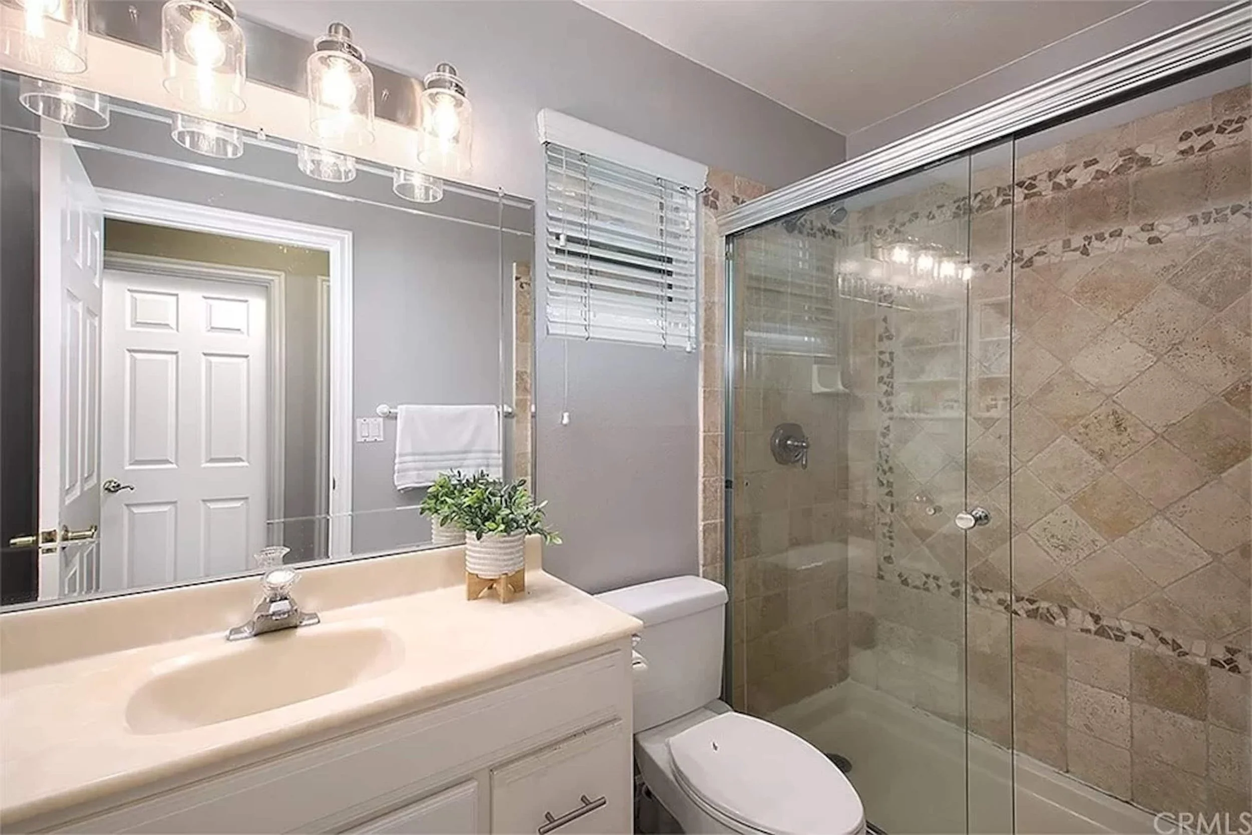Full bathroom with a glass-enclosed shower and vanity