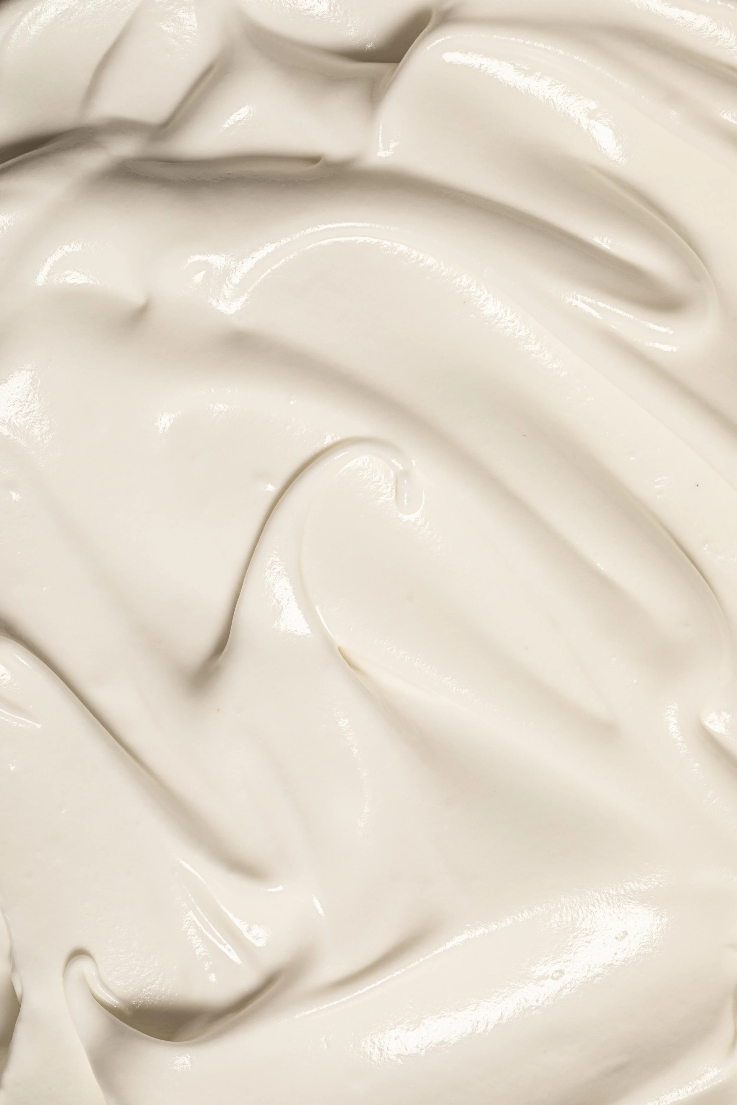 Close-up of a creamy, white substance with smooth, swirled texture.