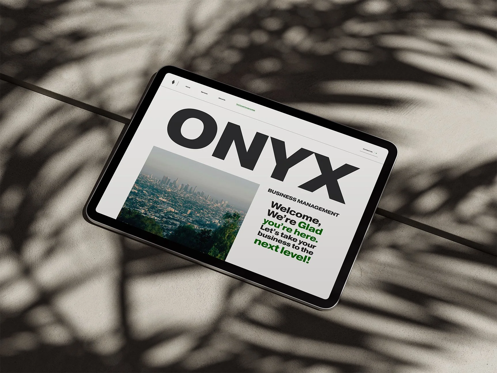 A tablet displaying a website with the large title 'ONYX' and text about business management.