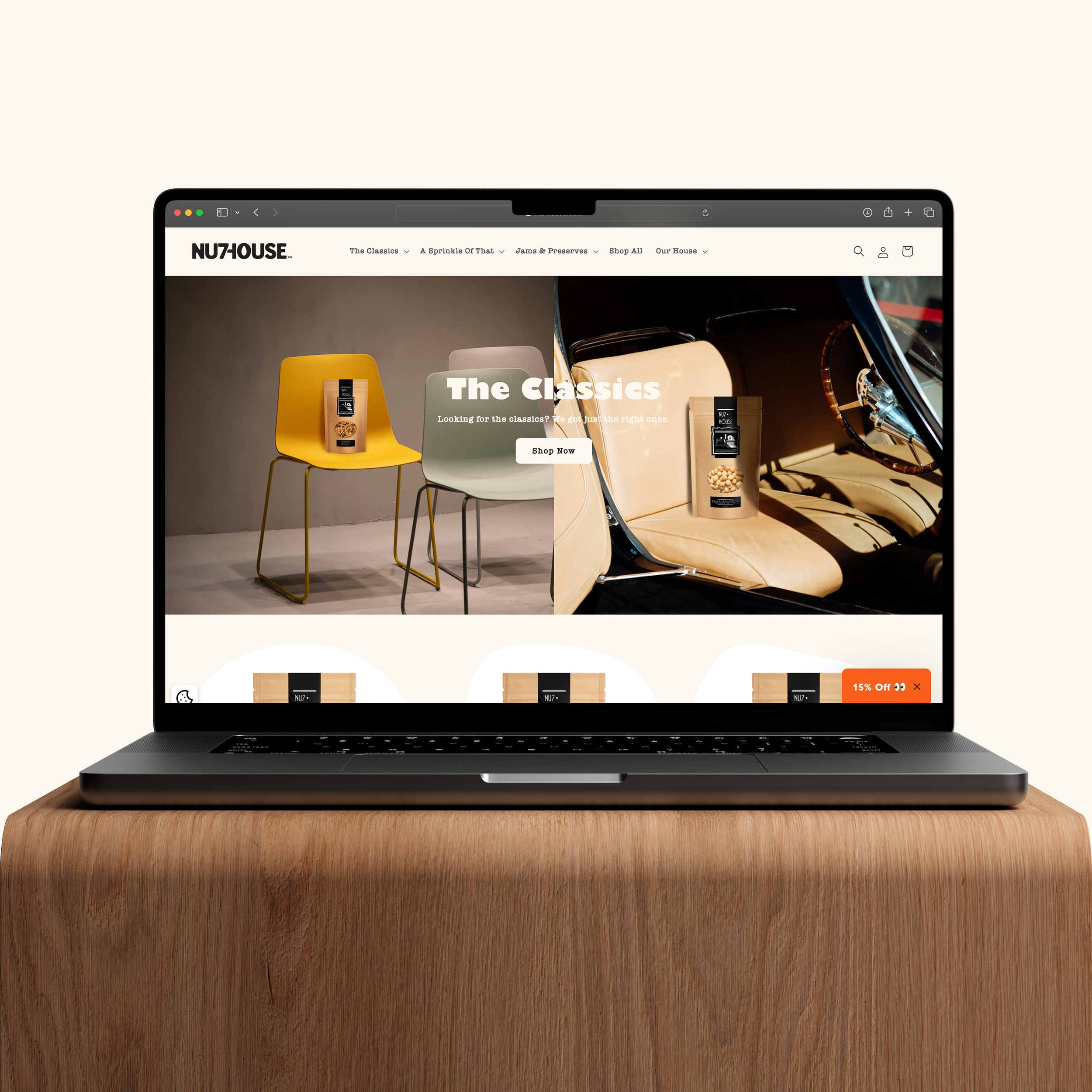 Laptop displaying an online shop webpage with chairs and snack packages on a wooden table.