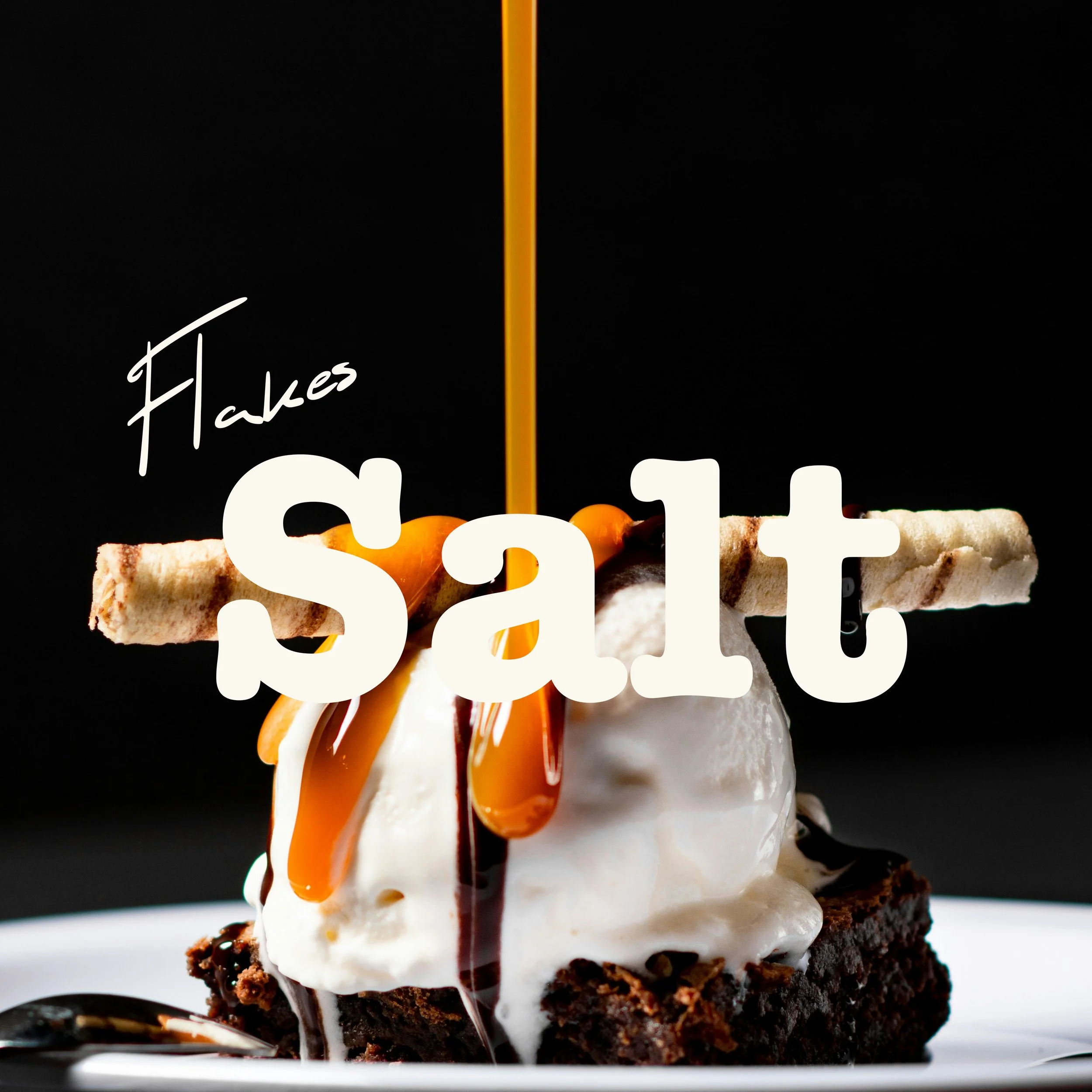 A slice of chocolate cake with vanilla ice cream and caramel drizzle.