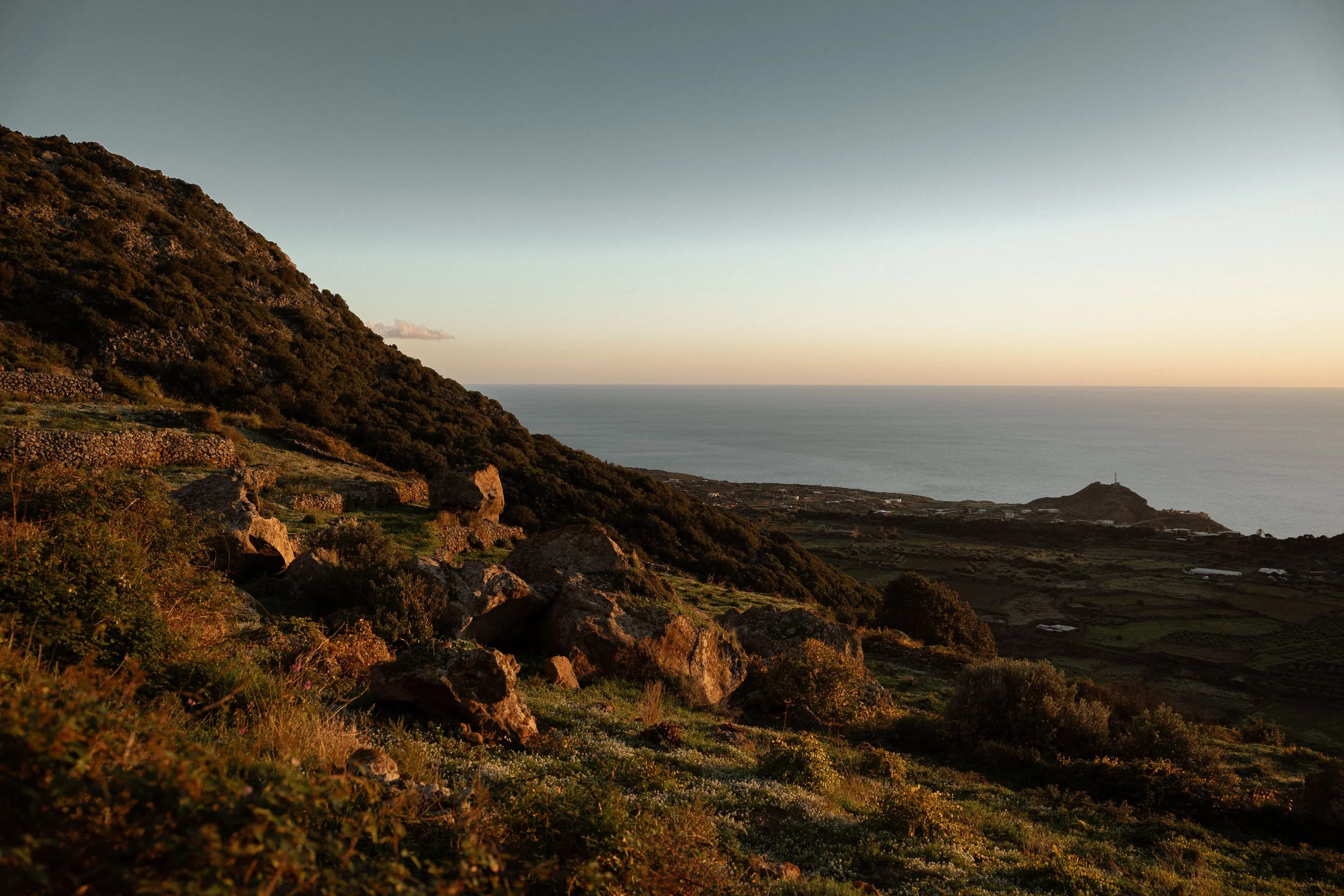 Scenic view of a hill with rocks and vegetation from the innerside of Pantelleria
