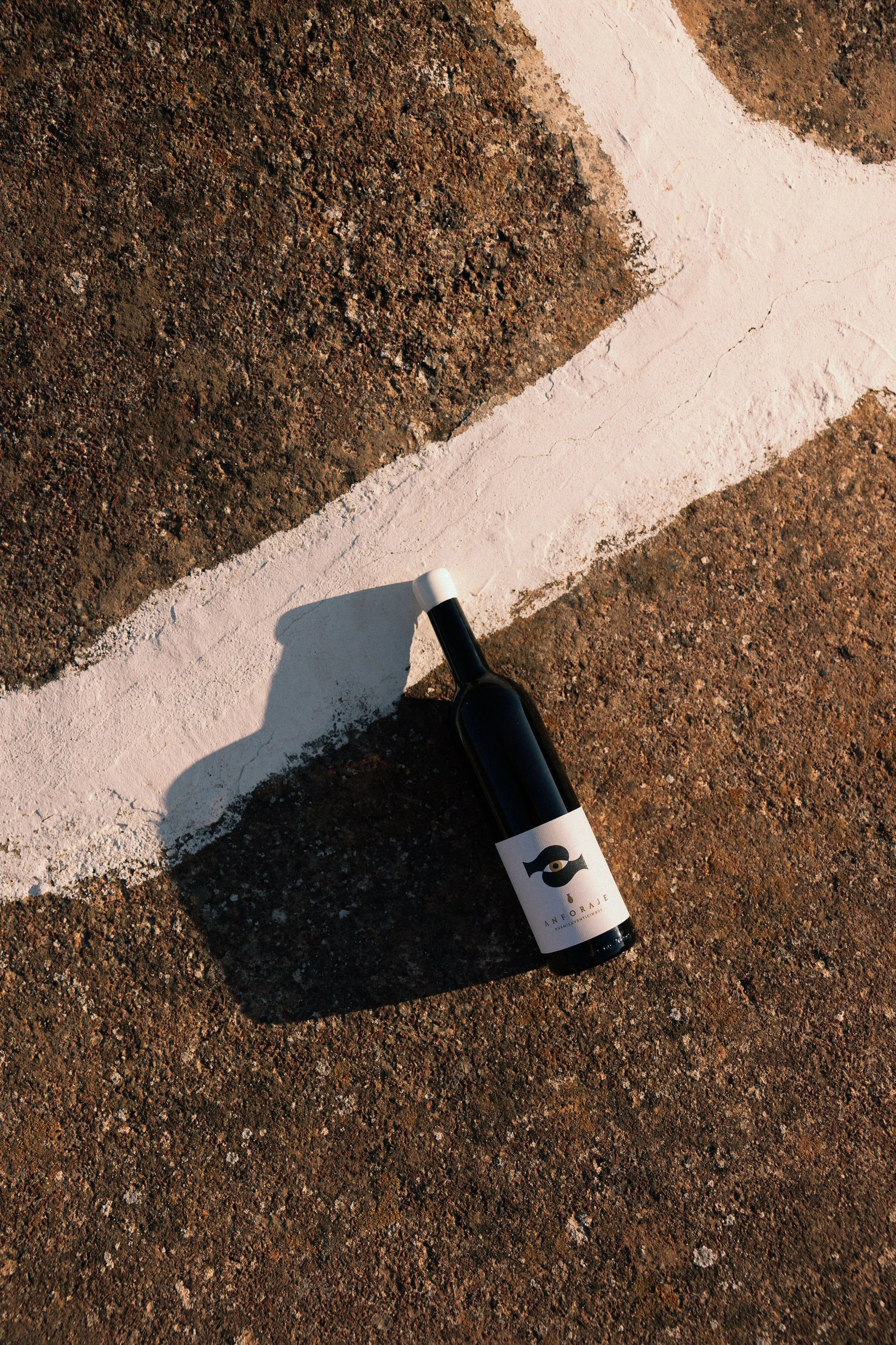A bottle of Anforaje white wine on the roof of a dammuso , in Pantelleria at sunset.