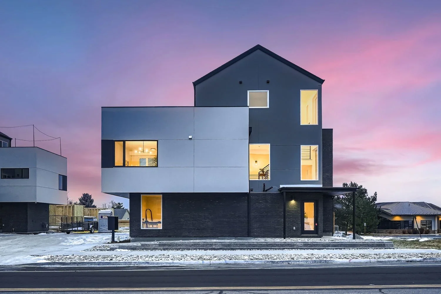 Exterior view of Art Line Townhomes at dusk, a modern urban infill development by The Rukavina Companies in Denver, Colorado