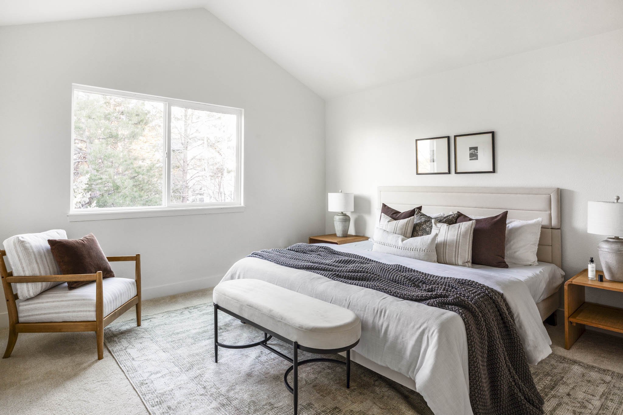 Primary bedroom with vaulted ceiling, upholstered headboard, and large window at 10499 Cheetah Winds in Lone Tree, Colorado, renovated by The Rukavina Companies