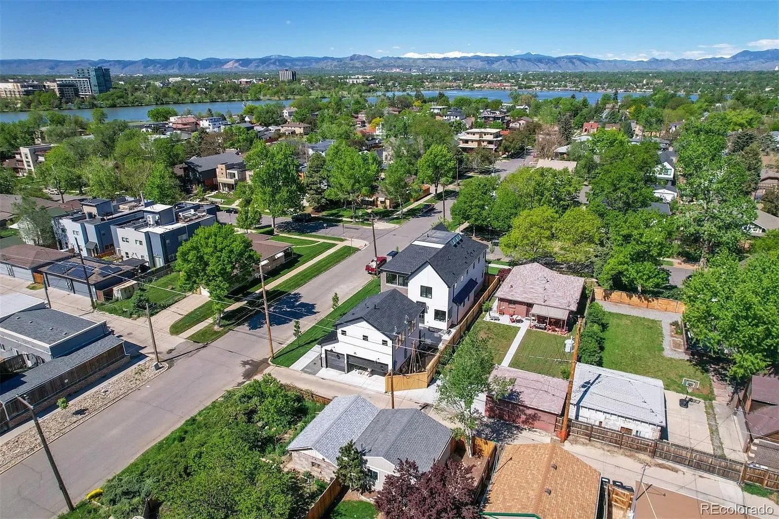 Aerial view of 2200 Newton Street in Sloan's Lake Denver, a new construction home by The Rukavina Companies with Rocky Mountain and lake views