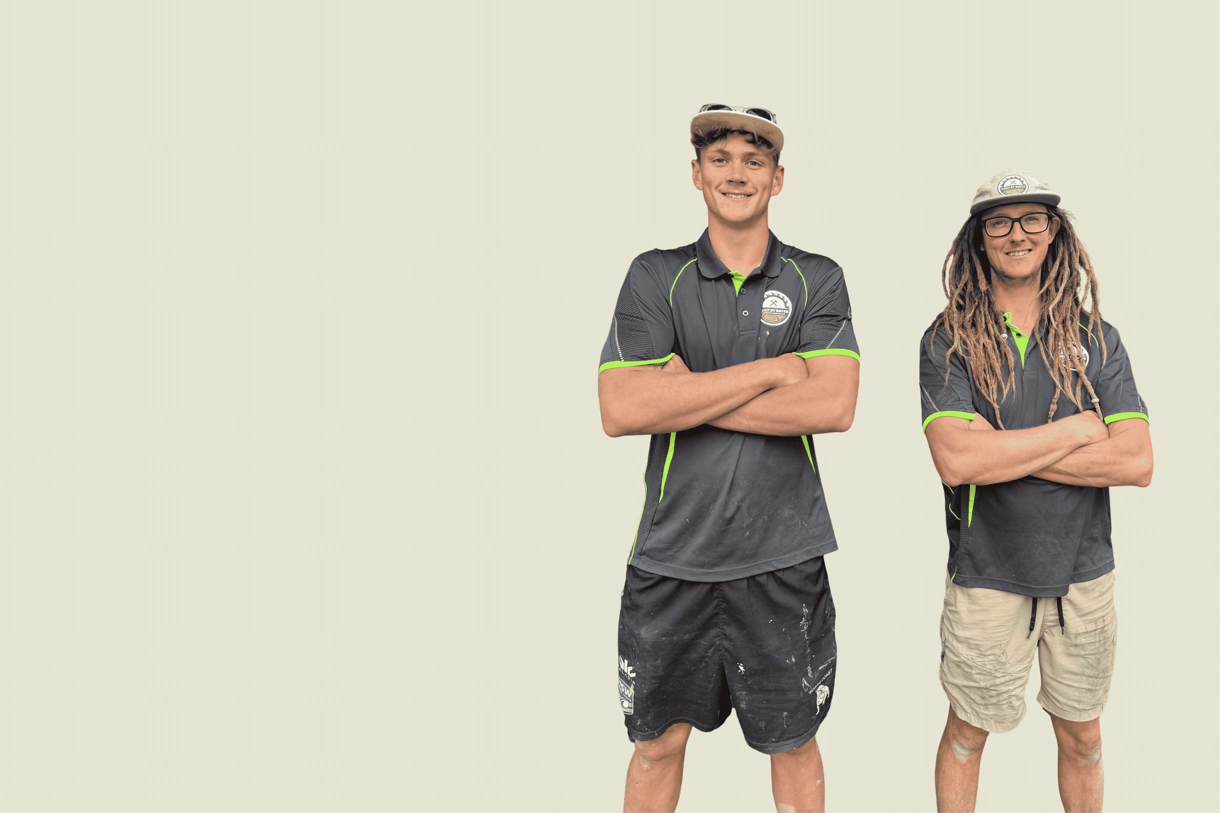 Two young men standing with crossed arms, wearing casual outdoor sportswear and hats, against a plain light background.
